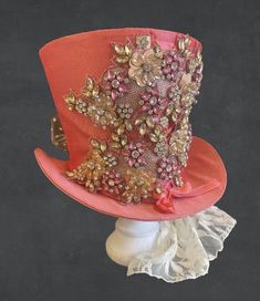 Victorian wedding steampunk  dusky pink top hat is made of hand crafted pinks and whites zirconia diamonds jewels and sequins embroidering  please refer to photos  It is very well made and is made of a silk  type of fabric. It is fully lined with black satin fabric. The front has jewels  with back lace train with bows and feathers  It is available in Size in 57cm Height 18cm   this is full head hat and not mini hat Please note any markings & traces of glue are characteristics of the fabric and n Jewel Top, Black Satin Fabric, Hat With Bow, Mini Hat, Victorian Wedding, Top Hats, Diamond Jewel, Dusky Pink, Pink Top