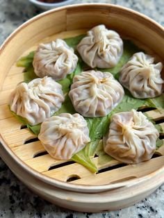 some dumplings are sitting in a wooden bowl