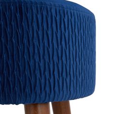 a blue stool with wooden legs and an upholstered cushion on the backrest