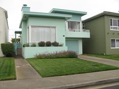 two houses with green grass in front of them