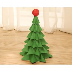 a paper christmas tree with a red ball on top