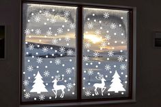 the window is decorated with snowflakes and trees