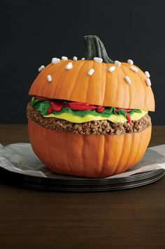 a pumpkin shaped like a hamburger sitting on top of a plate