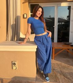 a woman standing on top of a counter next to a window