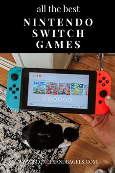 a person holding an orange and blue nintendo switch game controller in front of a black and white cat