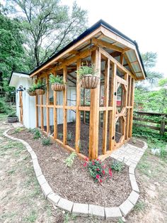 a small wooden structure with plants in it