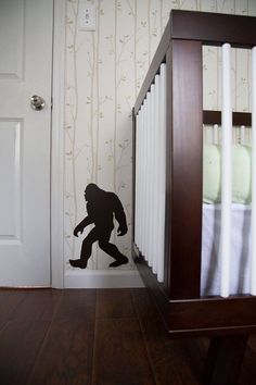 a silhouette of a bigfoot in front of a baby crib