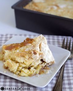 a piece of pie sitting on top of a white plate next to a baking pan