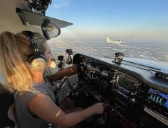 two women are sitting in the cockpit of an airplane and looking at the view from inside