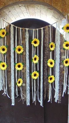 sunflowers and ribbons decorate the front door of a building