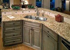 a kitchen with granite counter tops and wooden cabinets