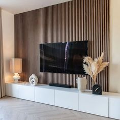 a living room with a large flat screen tv mounted on the side of a wall