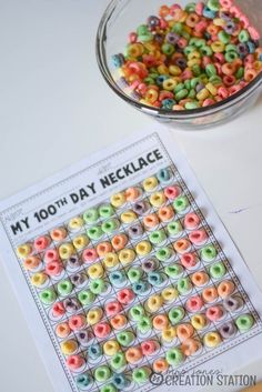 a glass bowl filled with cereal next to a printable my 100th day necklace