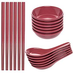 a set of red plastic plates and forks