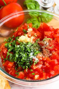 chopped tomatoes, parsley and seasoning in a glass bowl