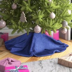 a small christmas tree with presents under it