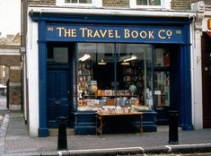 the travel book co store is on the side of the street