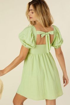 Feel pretty and sweet like spring in our Emilie dress! A beautiful pastel green mini dress featuring cut out detailing and a tie closure. Dress has a square neckline and flattering puff sleeves. Gorgeous cotton lightweight fabric. Lined and not sheer. Perfect for a fun picnic, winery trip or your next vacation! Complete the look with white heels or sandals for an easy, casual look. Pastel Green Square Neckline Puff Sleeves Lined Mini Length Model is 5' 7" and wearing size small. Recommended Sizi Tie Back Dress, Casual Glam, Dress With Puff Sleeves, No See, Top Skirt Set, Green Tie, Womens Tie, Puffed Sleeves Dress, Back Dress