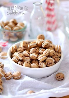 a bowl filled with cookies sitting on top of a table next to other food items