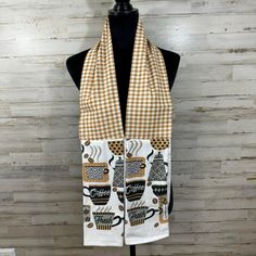 a white scarf with coffee cups on it