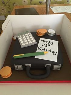 a birthday cake in the shape of a suitcase with a note attached to it that says happy 21st birthday