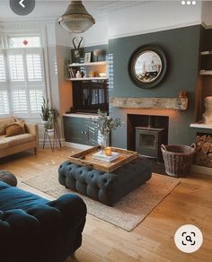 a living room filled with furniture and a fire place in the middle of a room