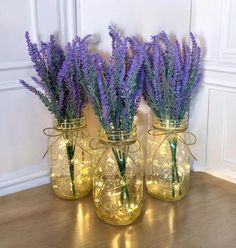 three mason jars with lavender flowers in them