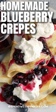 homemade blueberry crepes with whipped cream and fresh berries on top are ready to be eaten