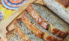 slices of banana bread on a cutting board with a yellow and blue flowered napkin