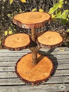 three tiered tree stump stand on top of a wooden bench