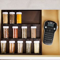 an open drawer containing spices and a calculator