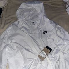 Nike White Windbreaker Jacket Never Worn Nike Long Sleeve Windbreaker With Pockets, Nike White Hooded Windbreaker, Nike White Outdoor Outerwear, White Hooded Nike Windbreaker, White Windbreaker With Pockets For Fall, White Windbreaker For Workwear In Winter, White Winter Windbreaker For Work, Nike White Outerwear With Pockets, White Nike Outerwear With Pockets