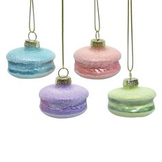 three different colored donuts hanging from strings