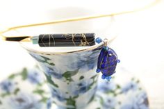 a pen sitting on top of a tea cup