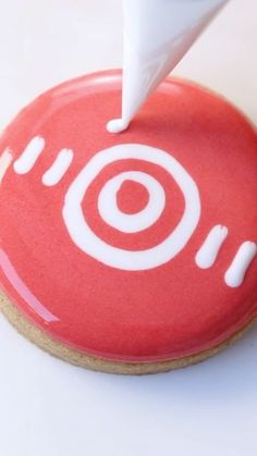 a cookie with white icing on top of it that has the word target painted on it