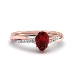 a heart shaped red diamond ring with diamonds on the band