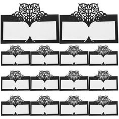 an assortment of black and white place cards with paper cutouts in the shape of trees