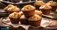 a bunch of muffins sitting on top of a wooden table