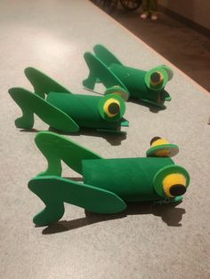 three green toy airplanes sitting on top of a counter next to each other in the shape of an airplane