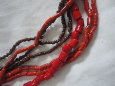 Here we have a Vintage 7 Strand Brown Red Shell Necklace, Native American Brown Red Shell Necklace, Southwest Brown Red Shell Necklace, Heishi Shells Red. This is a wonderful summertime Shell Necklace and it is in good condition with no flaws that we can see and it is 7 strands and 24 inches long as well. The color tone is brown and red and the beads are of different shapes and sizes but there are plenty of them... Any questions ask away... Red Multi-strand Coral Beaded Necklaces, Multi-strand Red Coral Necklace, Cat Piggy Bank, Spencers Gifts, Vintage Dressers, Brass Necklace, Shell Necklace, Chunky Necklace, Color Tone