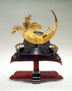 an elaborately decorated hat with gold leaf decoration