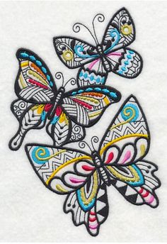 embroidered butterfly applique on white fabric with multicolored butterflies and swirls