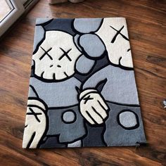 a rug with an image of two cartoon characters on it, sitting on the floor