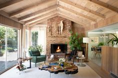 a living room filled with furniture and a fire place in the middle of a room