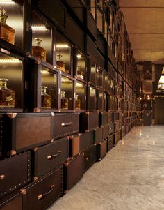 many drawers are lined up on the wall in an office building with gold trimmings