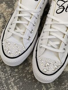 "Embroidered Platform Converse with pearls and bling on the toes and standard converse laces. (ribbon laces are available for an additional fee, please visit my shop for that shoe option!) (all orders will be with pearls and bling on toe unless you state otherwise) These are real converse with the built in platform! (approx 1\") They come with standard white laces. Getting Married? What a great idea. This listing is for Mrs (last Name) shoe with date on the side ! or a monogram. I will use red h White Embellished Lace-up Sneakers, Wedding Lace-up Sneakers With Rhinestones, Wedding White Embellished Sneakers, Wedding Low-top Sneakers With Rhinestones, Embellished Lace-up Sneakers For Weddings, Embellished Low-top Wedding Sneakers, Pearl Embellished Lace-up Wedding Sneakers, White Embellished Low-top Wedding Shoes, Lace-up Sneakers With Rhinestones For Anniversary