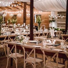 the tables are set up with candles and centerpieces for an elegant wedding reception