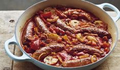 a blue pot filled with meat and vegetables