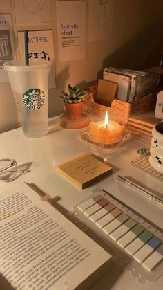 there is a candle and some books on the desk