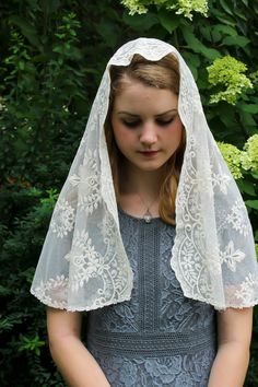 "A lovely& soft ivory veil, scattered with flowers. In two styles- infinity and D shape. A big thank you to our lovely customer for sharing her daughter's beautiful photo!! Infinity veil may be found here: https://www.etsy.com/listing/504244621/evintage-veils-our-lady-of-fatima-soft?ref=shop_home_feat_1 Also in a wrap-style, trimmed in Victorian inspired lace: https://www.etsy.com/listing/535548157/evintage-veils-our-lady-of-fatima-lace?ref=shop_home_feat_2 Lovely and very soft embroidered l Chapel Veils, Veil Mantilla, Catholic Veil, Lace Mantilla, Ivory Veil, Latin Mass, Head Coverings, Beautiful Veil, Flower Wreaths